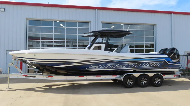 The Image of 2017 Sunsation 32 CCX boat on trailer, parked outside a building. - 0