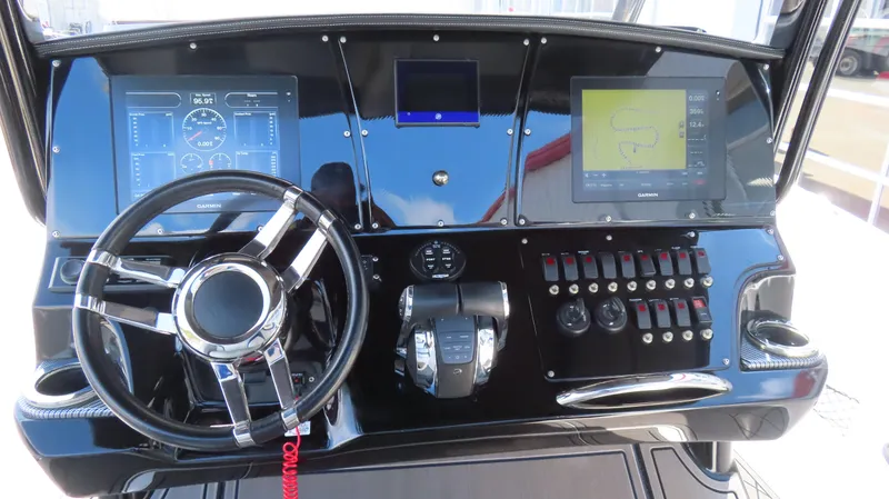 Slide: The Image of Control panel of 2017 Sunsation 32 CCX boat with steering wheel and digital displays. - 14