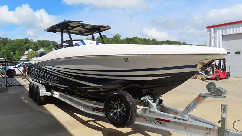 Slide: The Image of 2017 Sunsation 32 CCX boat on trailer, parked outdoors near a building. - 6