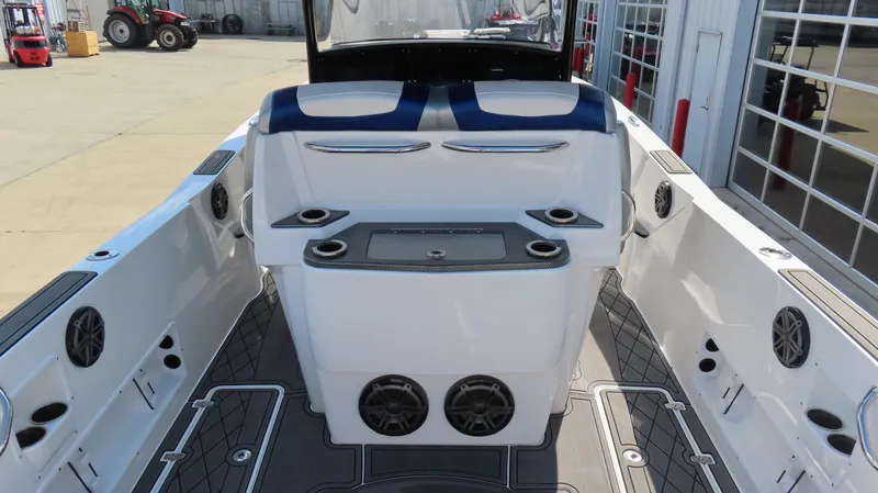 Slide: The Image of 2017 Sunsation 32 CCX boat interior with seating, cup holders, and speakers. - 8