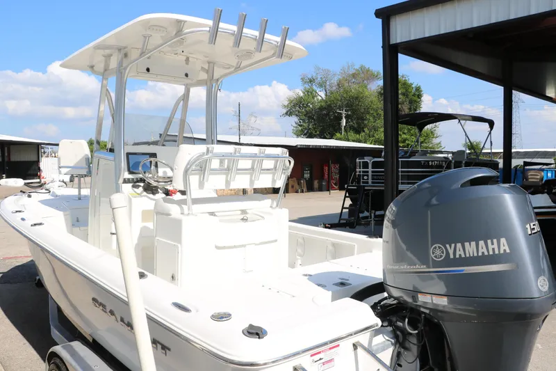 Slide: The Image of 2015 Sea Hunt BX22BR boat with Yamaha 150 engine, parked outdoors. - 12