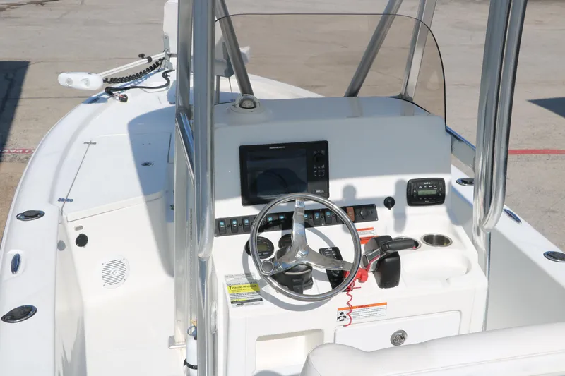 Slide: The Image of 2015 Sea Hunt BX22BR boat console with steering wheel and navigation equipment. - 16