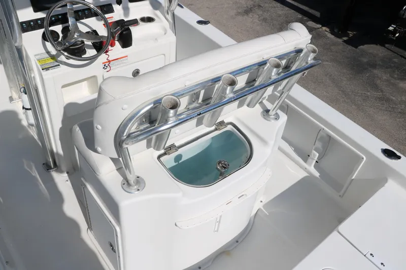 Slide: The Image of 2015 Sea Hunt BX22BR boat interior with steering wheel, rod holders, and livewell. - 17