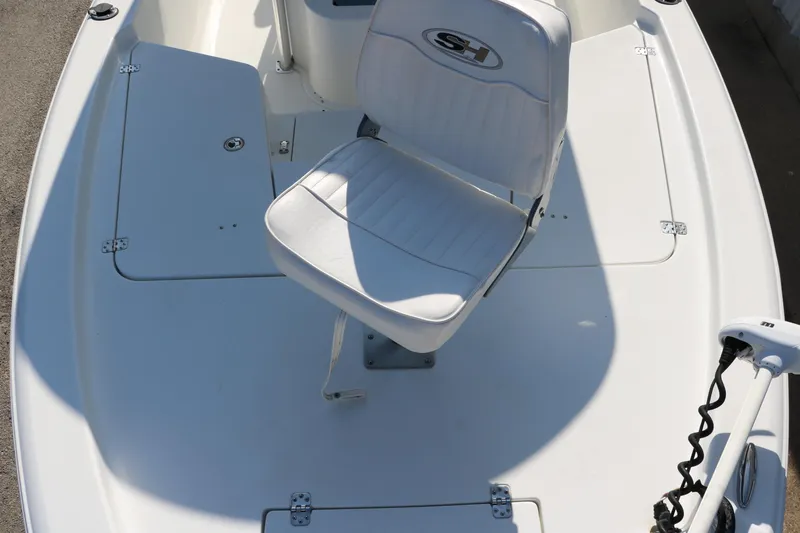 Slide: The Image of 2015 Sea Hunt BX22BR boat deck with white seating and storage compartments. - 19