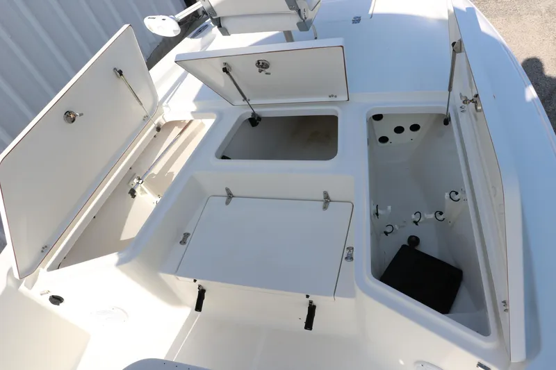 Slide: The Image of 2015 Sea Hunt BX22BR boat storage compartments open, showcasing spacious interior design. - 23