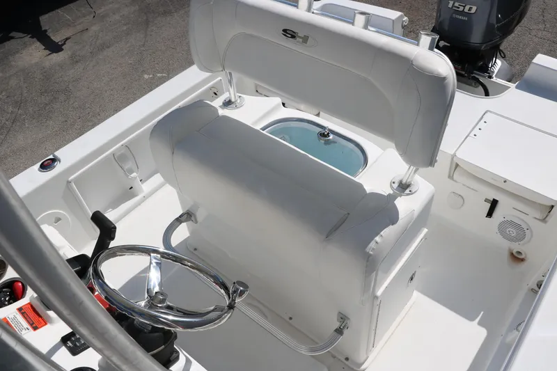 Slide: The Image of 2015 Sea Hunt BX22BR boat interior with steering wheel and seating. - 25