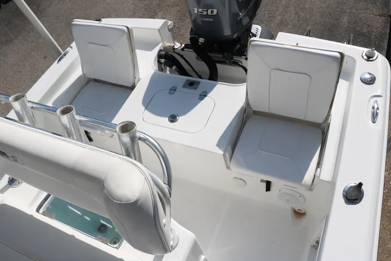 Slide: The Image of 2015 Sea Hunt BX22BR boat interior with seating and Yamaha 150 engine. - 27