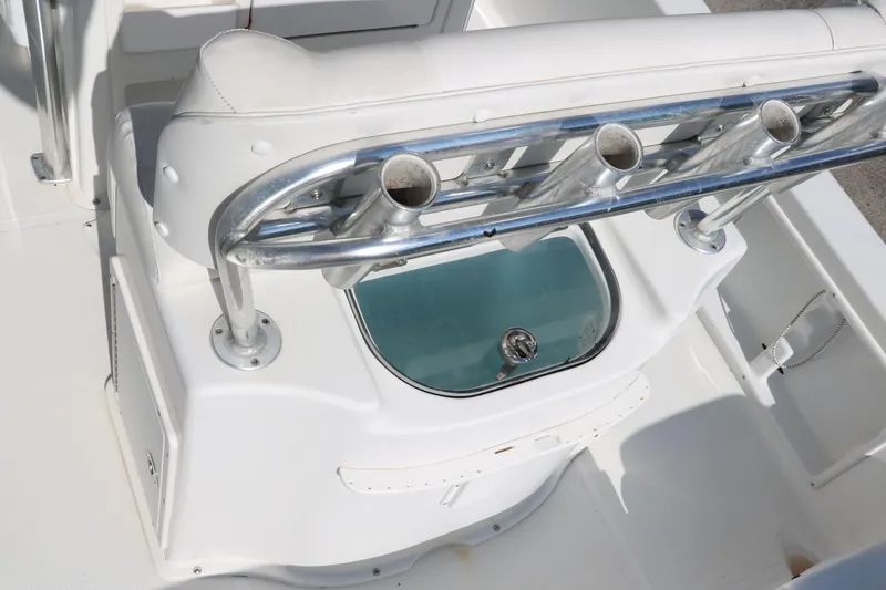 Slide: The Image of 2015 Sea Hunt BX22BR boat interior with rod holders and livewell. - 28