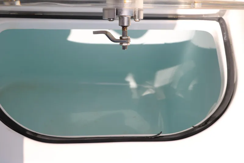 Slide: The Image of Livewell interior of a 2015 Sea Hunt BX22BR boat, featuring a water inlet valve. - 32