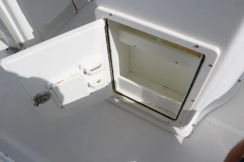 Slide: The Image of Open storage compartment on a 2015 Sea Hunt BX22BR boat. - 34