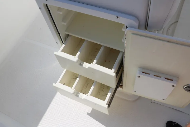 Slide: The Image of Open storage compartment with dividers on a 2015 Sea Hunt BX22BR boat. - 35