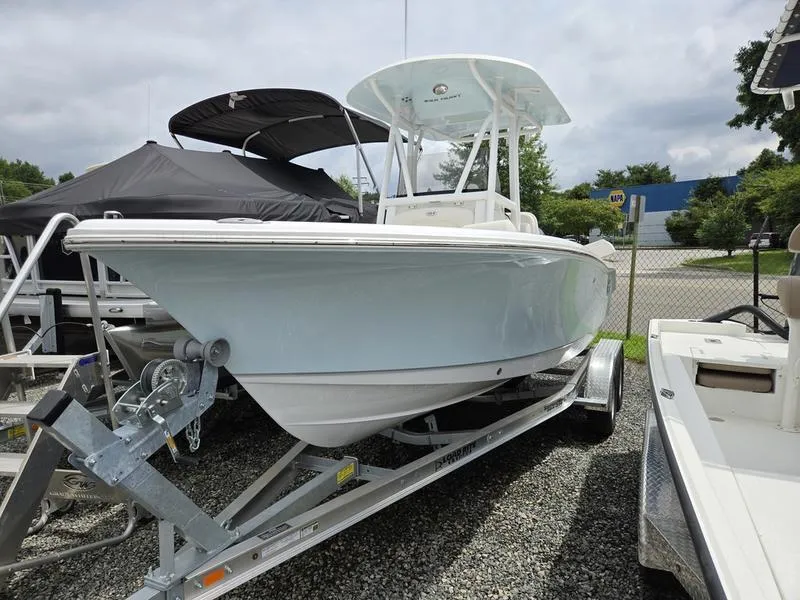 Slide: The Image of 2025 Sea Hunt Ultra 219 boat on trailer, displayed outdoors. - 1