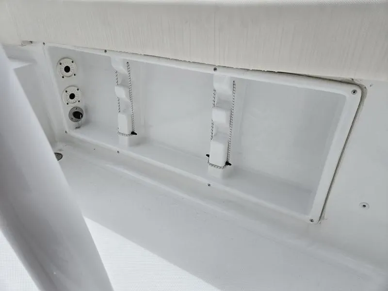 Slide: The Image of 2025 Sea Hunt Ultra 219 boat interior compartment with white fittings and fixtures. - 12