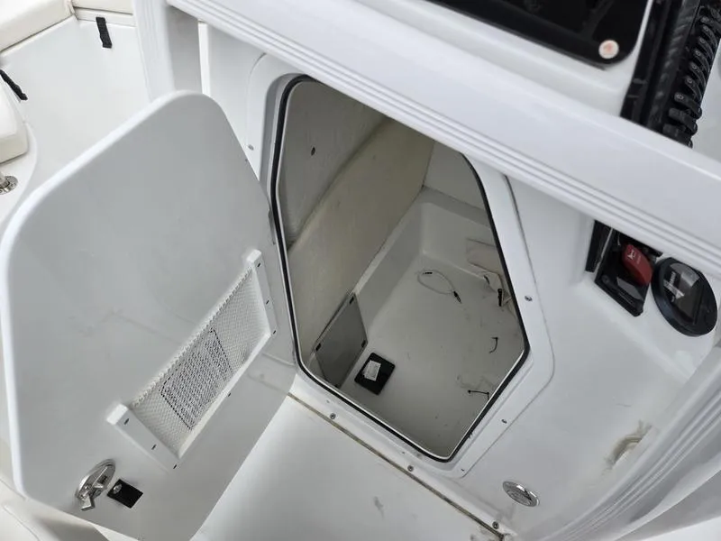 Slide: The Image of Open storage compartment on 2025 Sea Hunt Ultra 219 boat, showcasing interior space. - 5