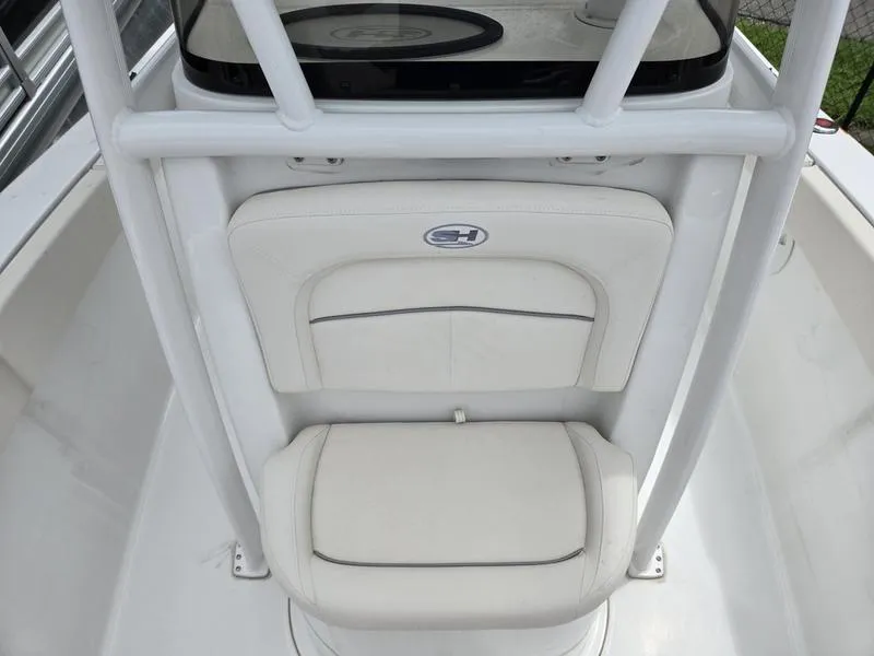 Slide: The Image of 2025 Sea Hunt Ultra 219 boat seat with white upholstery and logo detail. - 6