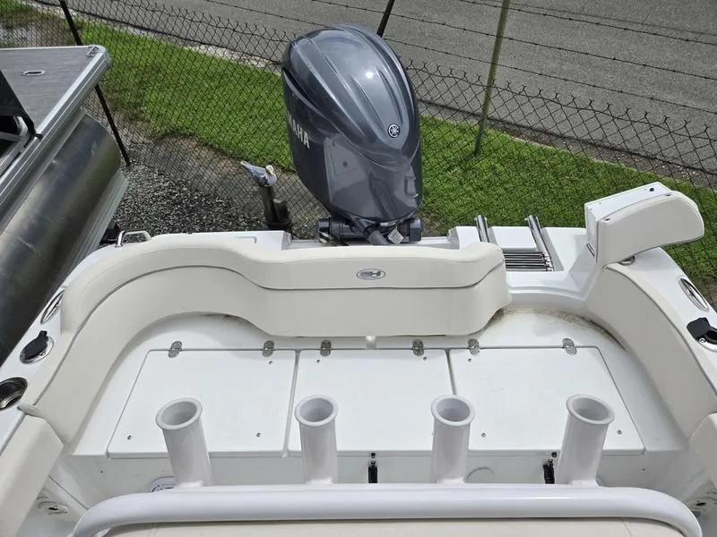 Slide: The Image of 2025 Sea Hunt Ultra 219 boat with Yamaha outboard motor, featuring rod holders and seating. - 8