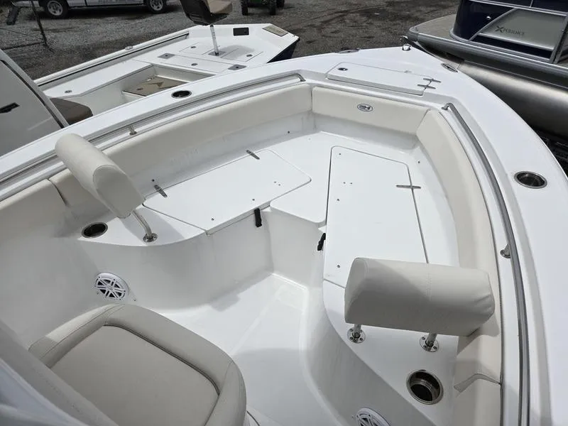 Slide: The Image of 2025 Sea Hunt Ultra 219 boat interior with white seating and storage compartments. - 9