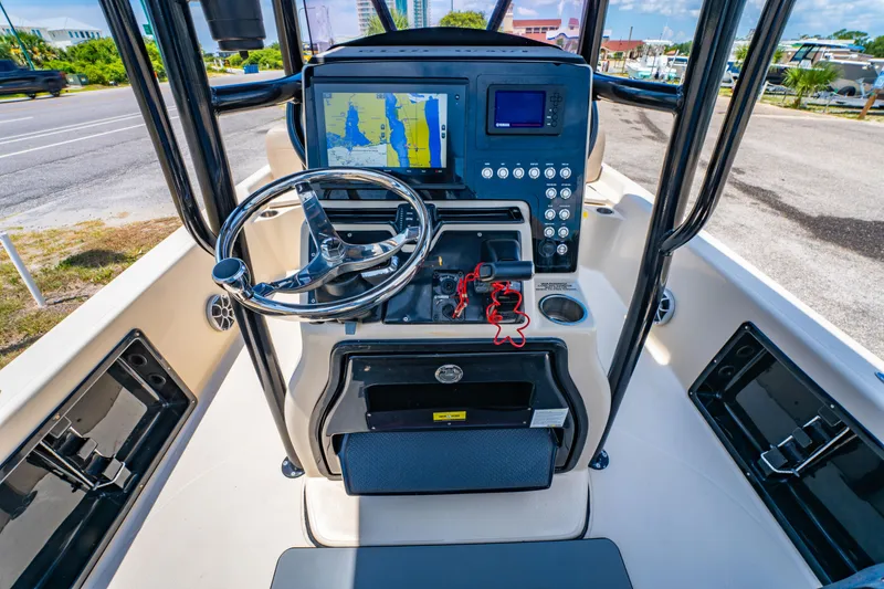 Slide: The Image of 2020 Blue Wave 2400 PureBay boat dashboard with navigation system and steering wheel. - 14