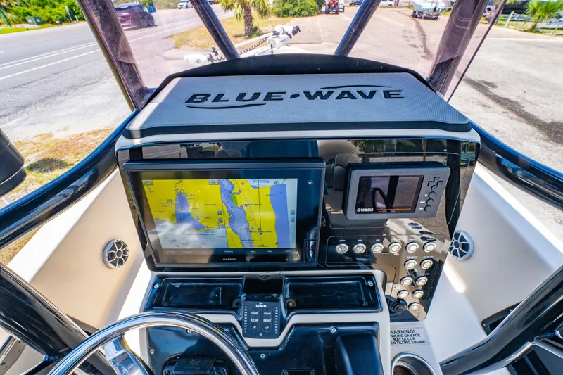 Slide: The Image of 2020 Blue Wave 2400 PureBay boat dashboard with navigation screens and controls. - 15