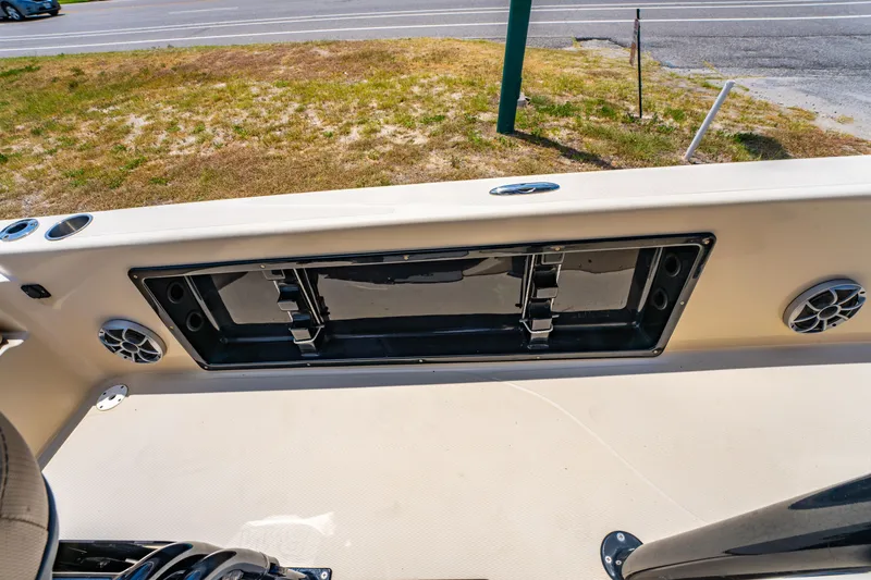 Slide: The Image of 2020 Blue Wave 2400 PureBay boat interior with storage compartment and speakers. - 25