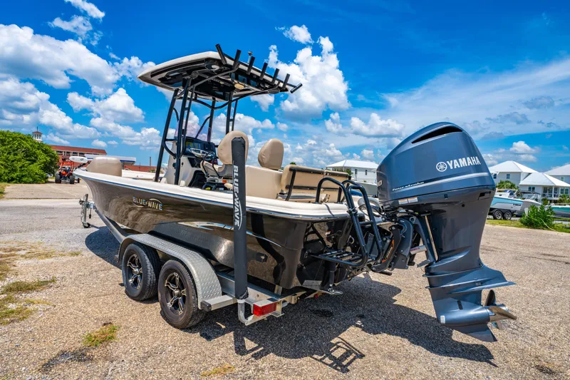 Slide: The Image of 2020 Blue Wave 2400 PureBay boat with Yamaha engine on trailer under blue sky. - 5