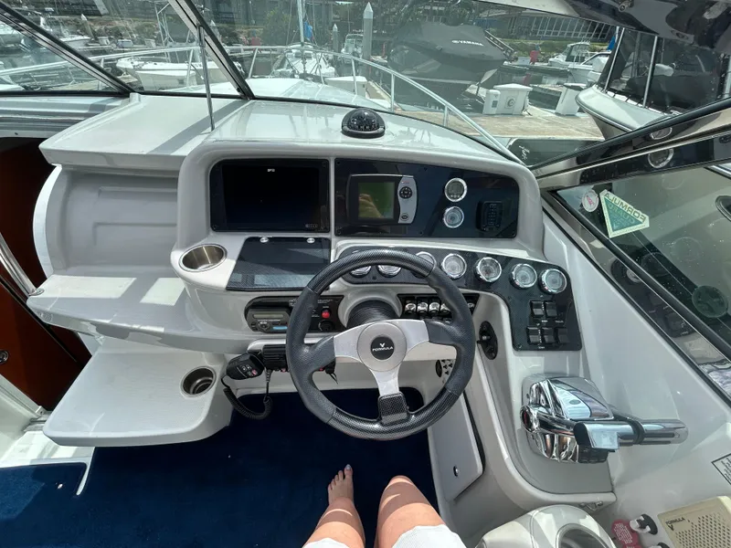 Slide: The Image of 2007 Formula 330 Sun Sport boat cockpit with steering wheel and control panel. - 10