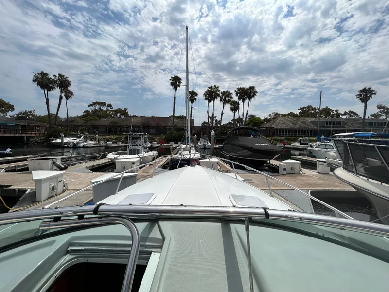 Slide: The Image of 2007 Formula 330 Sun Sport docked at marina with palm trees and cloudy sky. - 11