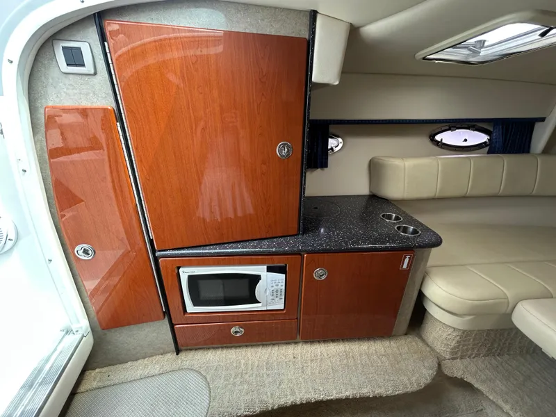 Slide: The Image of 2007 Formula 330 Sun Sport interior with kitchenette, microwave, and seating area. - 15