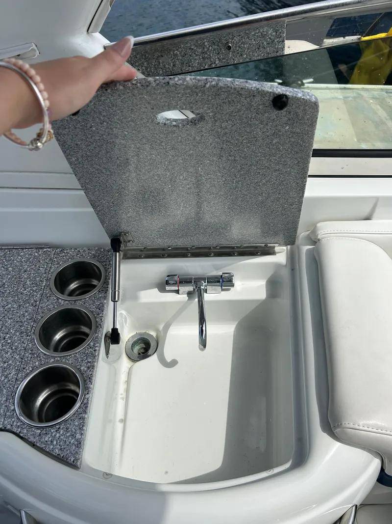 Slide: The Image of 2007 Formula 330 Sun Sport boat sink with cover and cup holders. - 18