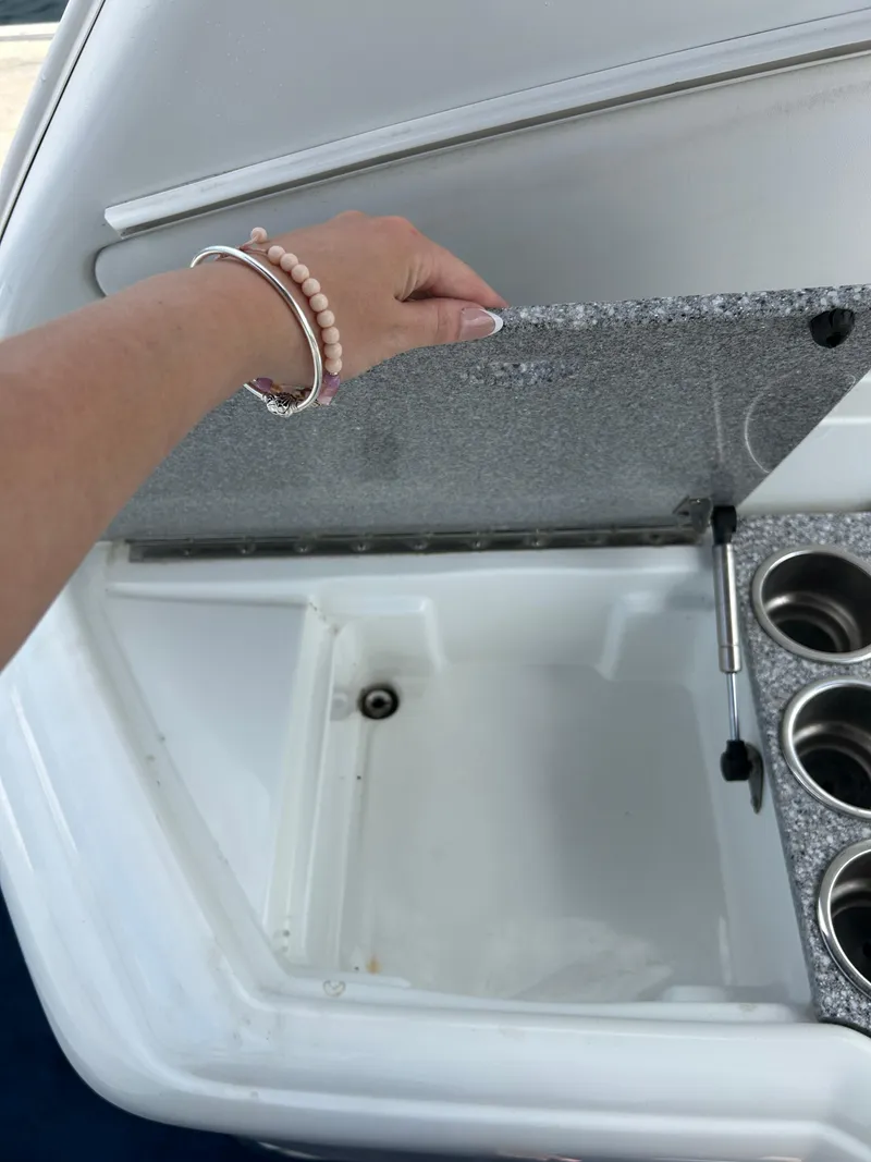 Slide: The Image of Hand opening storage compartment on 2007 Formula 330 Sun Sport boat. - 19