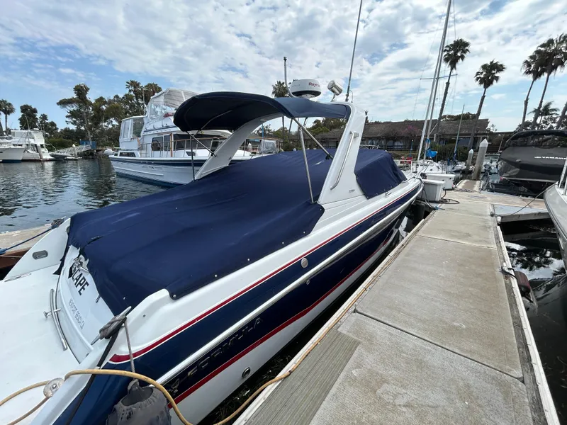 Slide: The Image of 2007 Formula 330 Sun Sport boat docked at marina with blue cover and palm trees. - 2