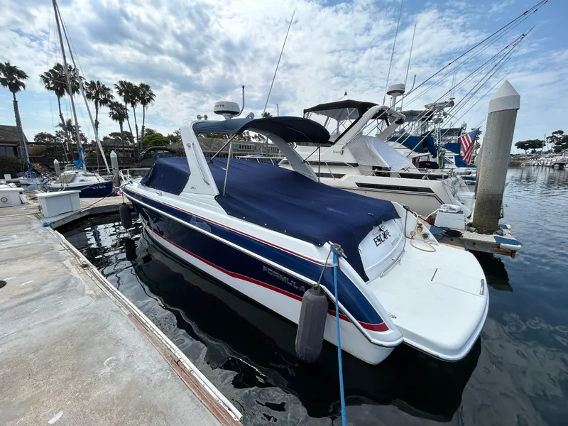 Slide: The Image of 2007 Formula 330 Sun Sport boat docked at marina, covered with blue tarp. - 5