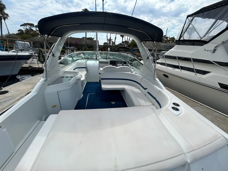 Slide: The Image of 2007 Formula 330 Sun Sport boat with spacious seating and canopy, docked at marina. - 6