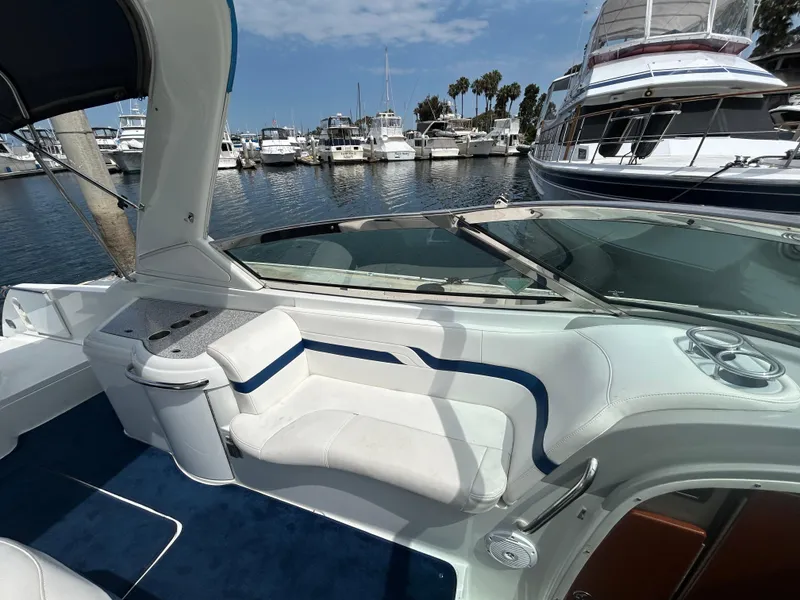 Slide: The Image of 2007 Formula 330 Sun Sport boat interior with white seating, docked at marina. - 9