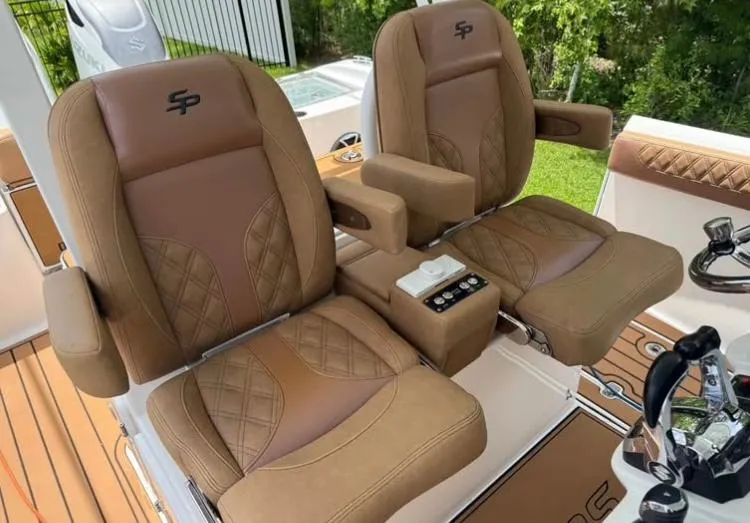 Slide: The Image of Luxurious seating on 2022 Sea Pro 320 DLX Offshore boat, featuring brown leather upholstery. - 6