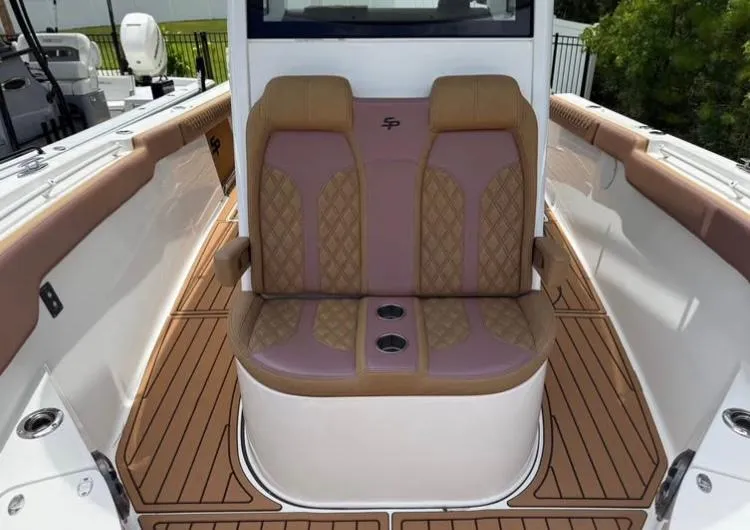 Slide: The Image of 2022 Sea Pro 320 DLX Offshore boat seating with tan and purple upholstery. - 8