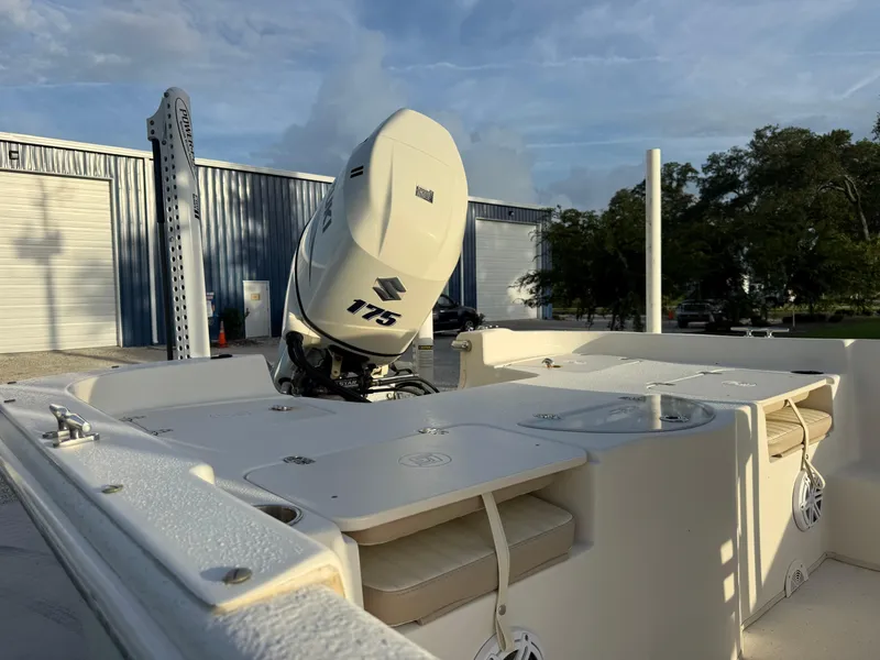 Slide: The Image of 2016 Carolina Skiff 238DLV boat with Suzuki 175 engine, parked outdoors. - 10