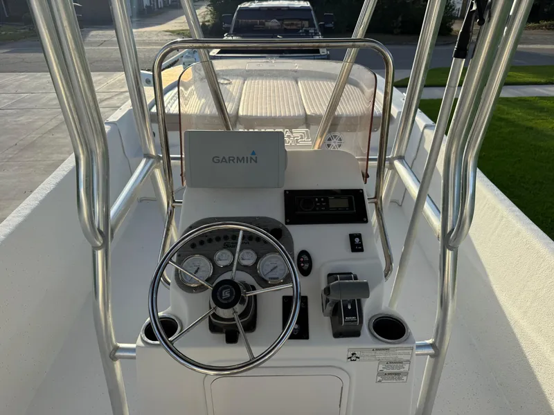 Slide: The Image of 2016 Carolina Skiff 238DLV boat console with Garmin navigation system and steering wheel. - 11