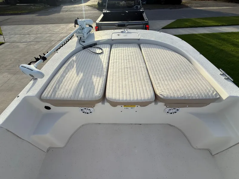 Slide: The Image of 2016 Carolina Skiff 238DLV boat deck with cushioned seating and trolling motor. - 13