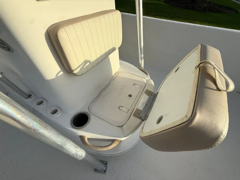 Slide: The Image of 2016 Carolina Skiff 238DLV boat seat with storage compartment and cup holder. - 15