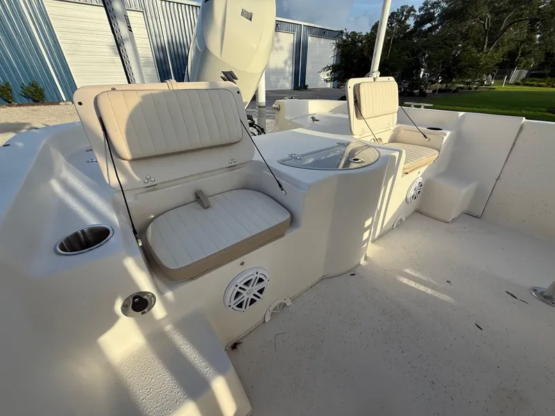 Slide: The Image of 2016 Carolina Skiff 238DLV boat interior with cushioned seating and storage compartments. - 16