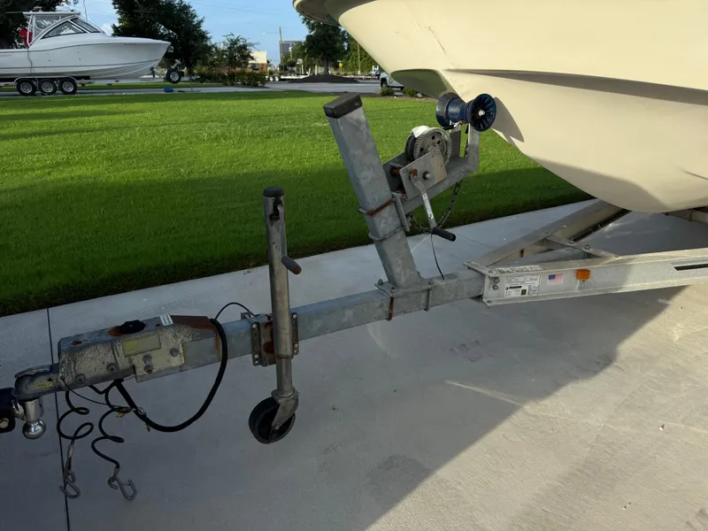 Slide: The Image of 2016 Carolina Skiff 238DLV boat on trailer, parked on concrete driveway. - 24