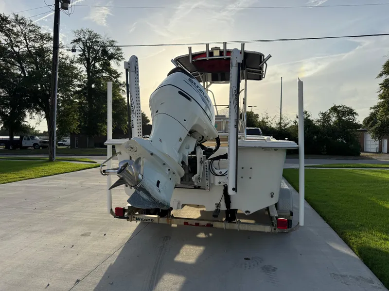 Slide: The Image of 2016 Carolina Skiff 238DLV boat on trailer, rear view with outboard motor. - 4