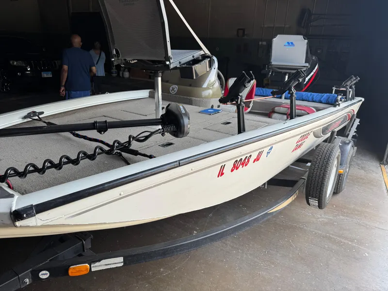 Slide: The Image of 2004 Lowe 170W boat on trailer in garage setting. - 13