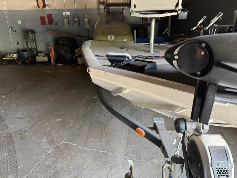 Slide: The Image of 2004 Lowe 170W boat in a garage, showing trailer and equipment. - 15