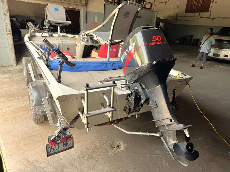 Slide: The Image of 2004 Lowe 170W boat with Mercury 50 engine in a garage setting. - 17