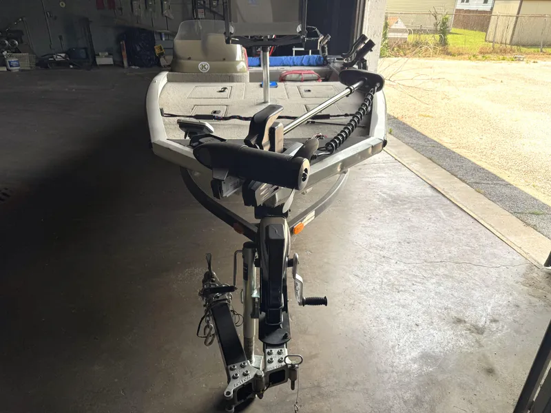 Slide: The Image of 2004 Lowe 170W boat in garage, featuring a trolling motor and spacious deck. - 7
