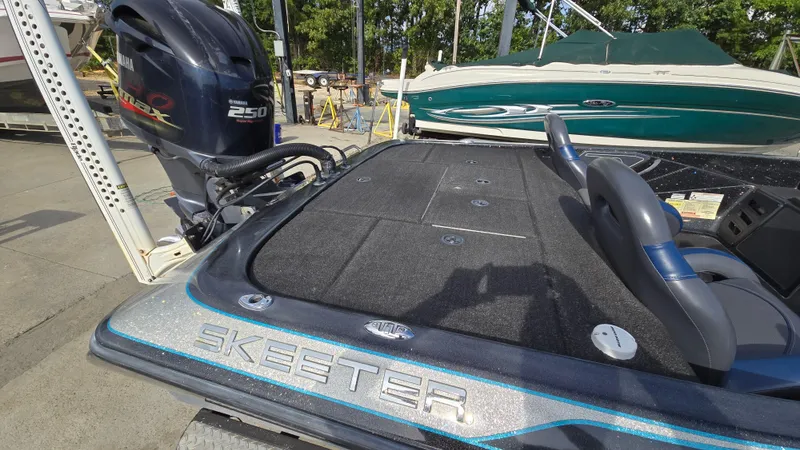 Slide: The Image of 2017 Skeeter ZX 250 boat with Yamaha 250 engine, parked outdoors. - 10