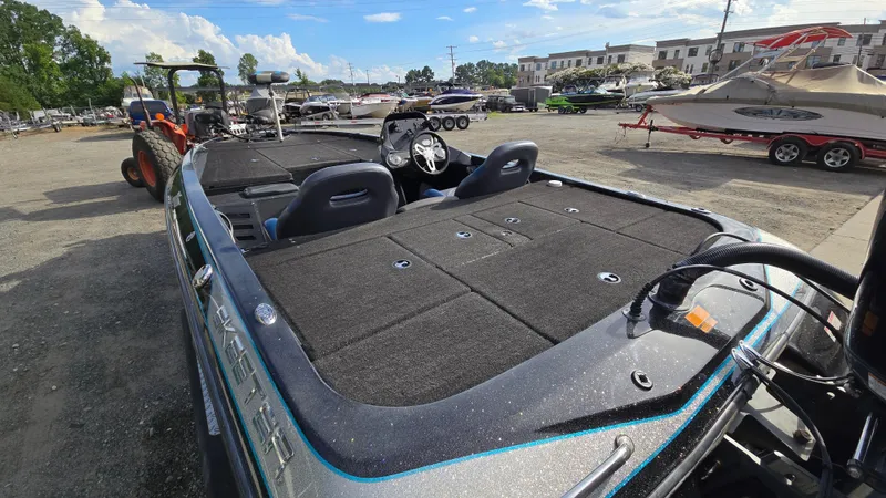 Slide: The Image of 2017 Skeeter ZX 250 boat in a marina, showcasing spacious deck and seating. - 11