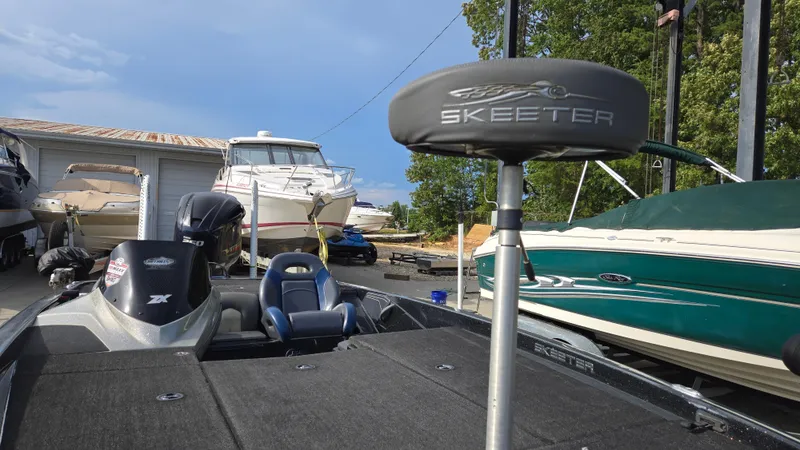 Slide: The Image of 2017 Skeeter ZX 250 boat with seating, parked among other boats in a marina. - 16